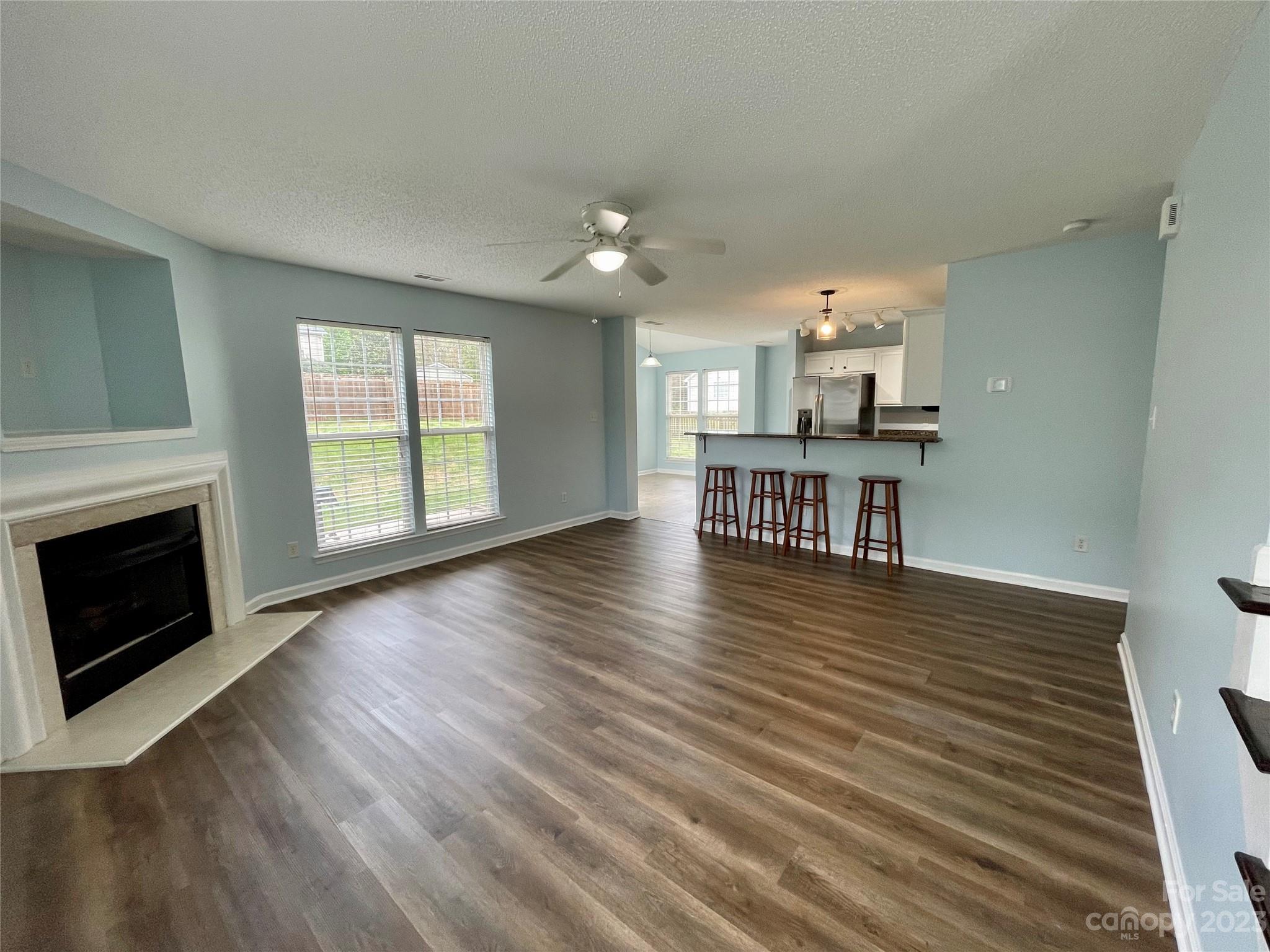4045 Suttle Place Matthews, NC 28104 - Photo 12 of 42 a view of a livingroom with furniture wooden floor fireplace and windows