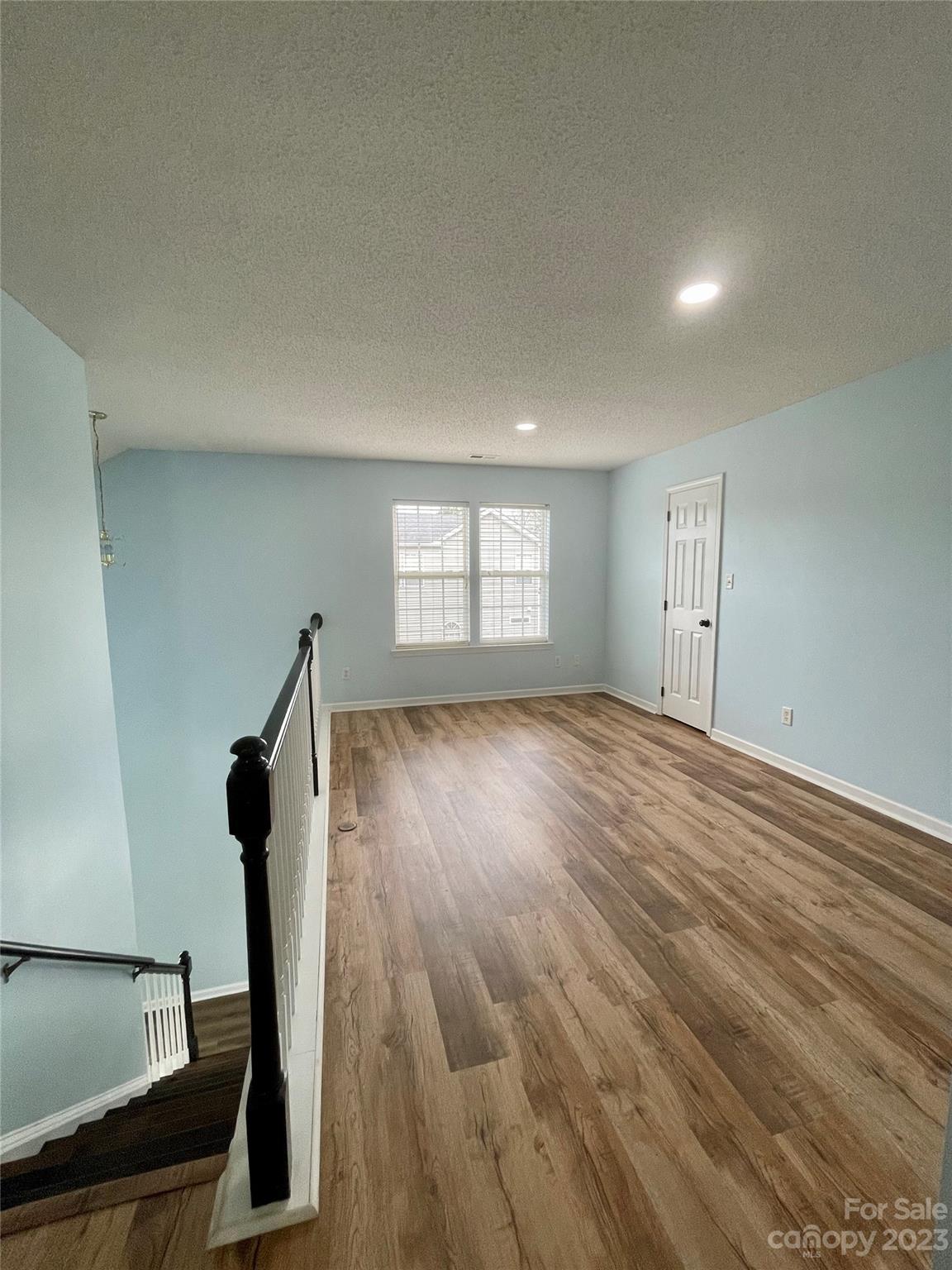 4045 Suttle Place Matthews, NC 28104 - Photo 19 of 42 a view of empty room with windows and wooden floor