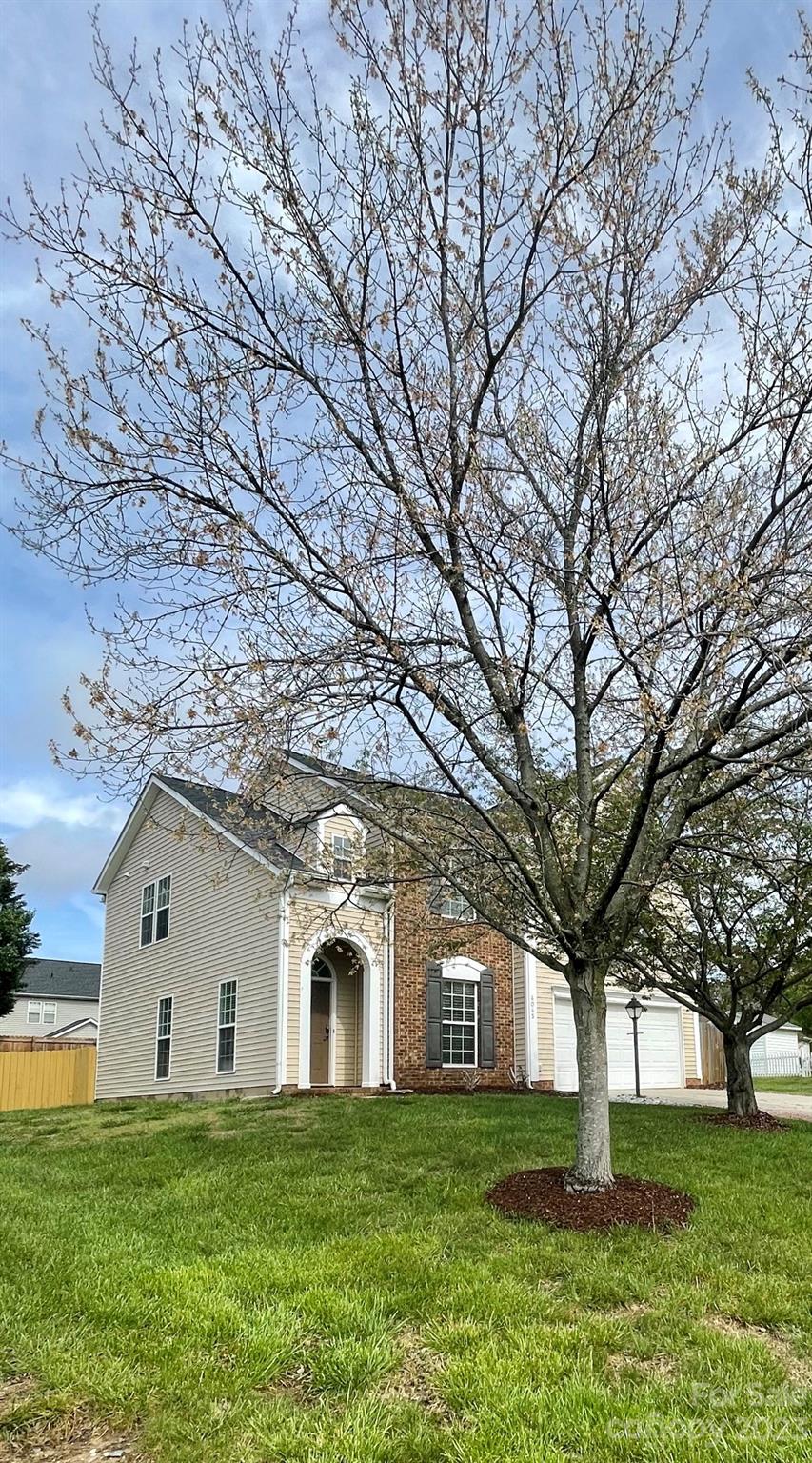 4045 Suttle Place Matthews, NC 28104 - Photo 2 of 42 a front view of a house with a garden
