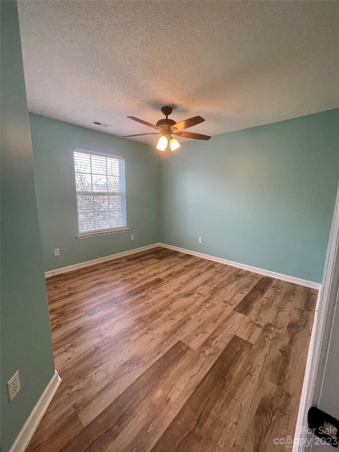 4045 Suttle Place Matthews, NC 28104 - Photo 24 of 42 an empty room with windows and fan