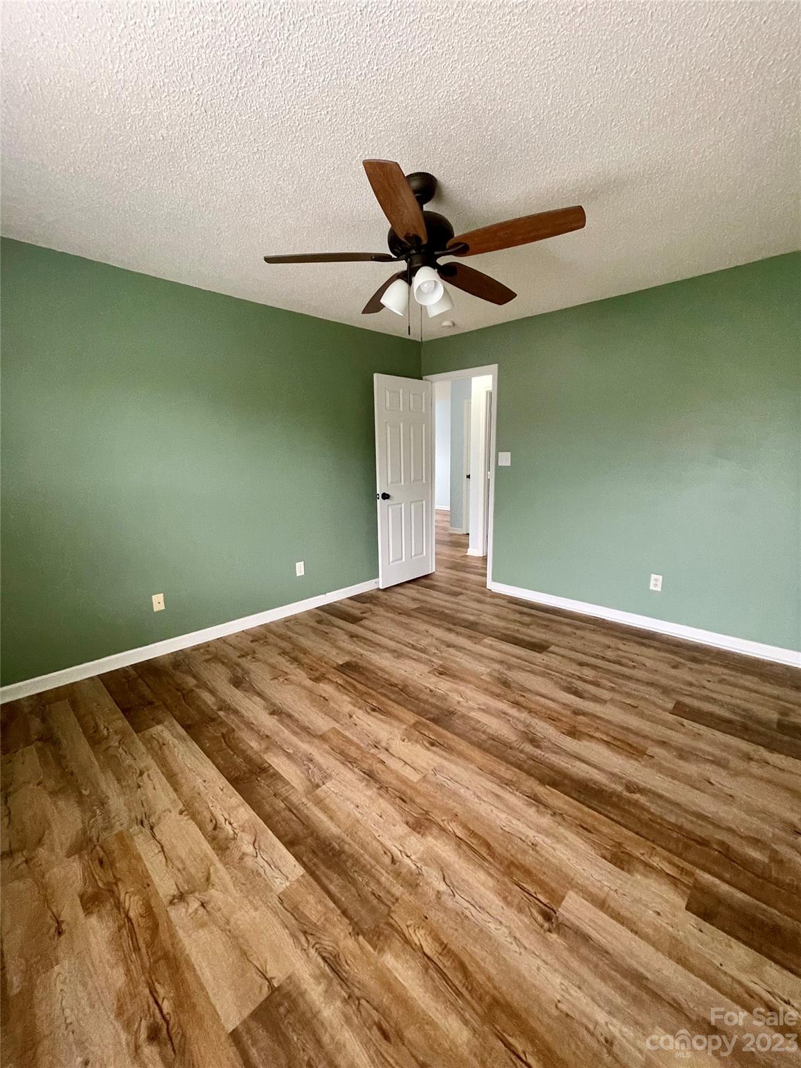 4045 Suttle Place Matthews, NC 28104 - Photo 29 of 42 a view of a room with a ceiling fan and wooden floor