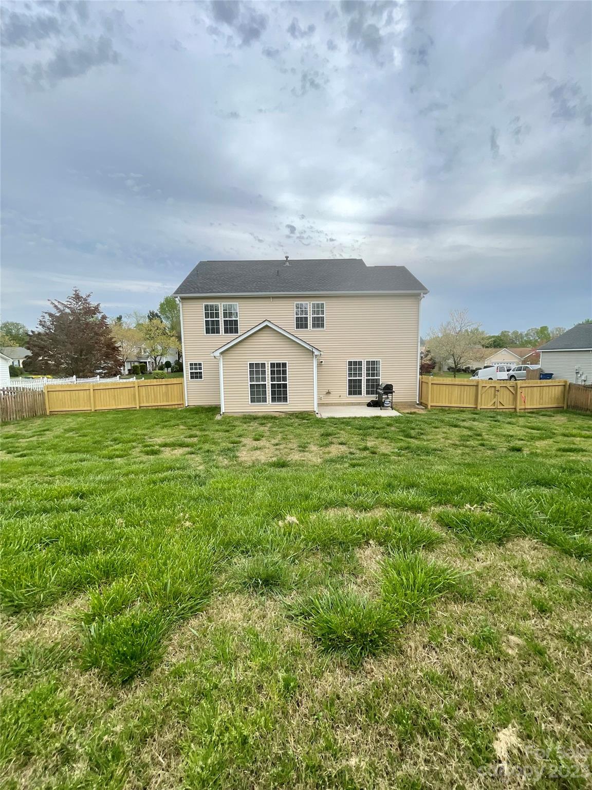 4045 Suttle Place Matthews, NC 28104 - Photo 42 of 42 a view of a house with a big yard and large trees