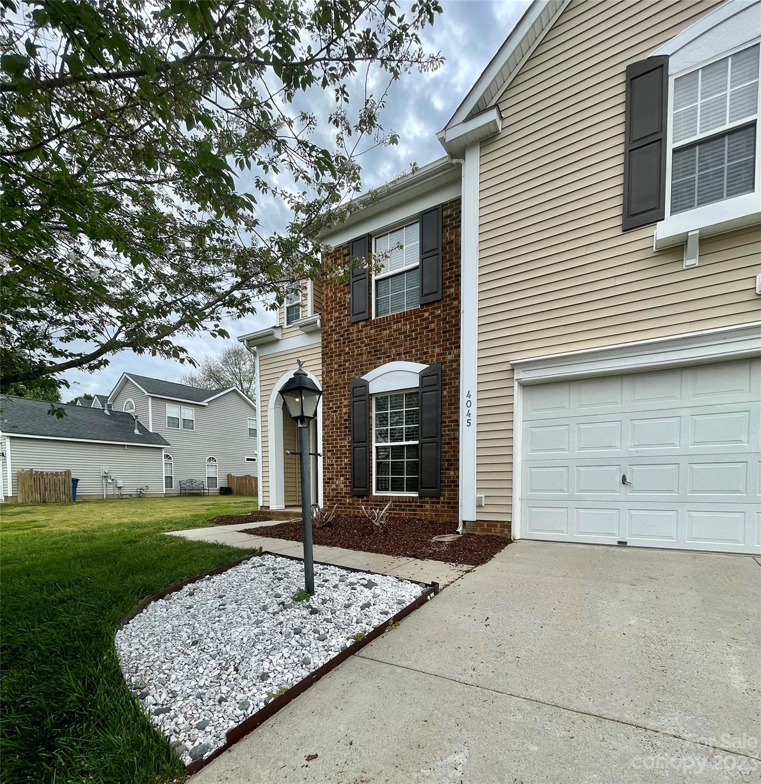 4045 Suttle Place Matthews, NC 28104 - Photo 5 of 42 a front view of a house with garden