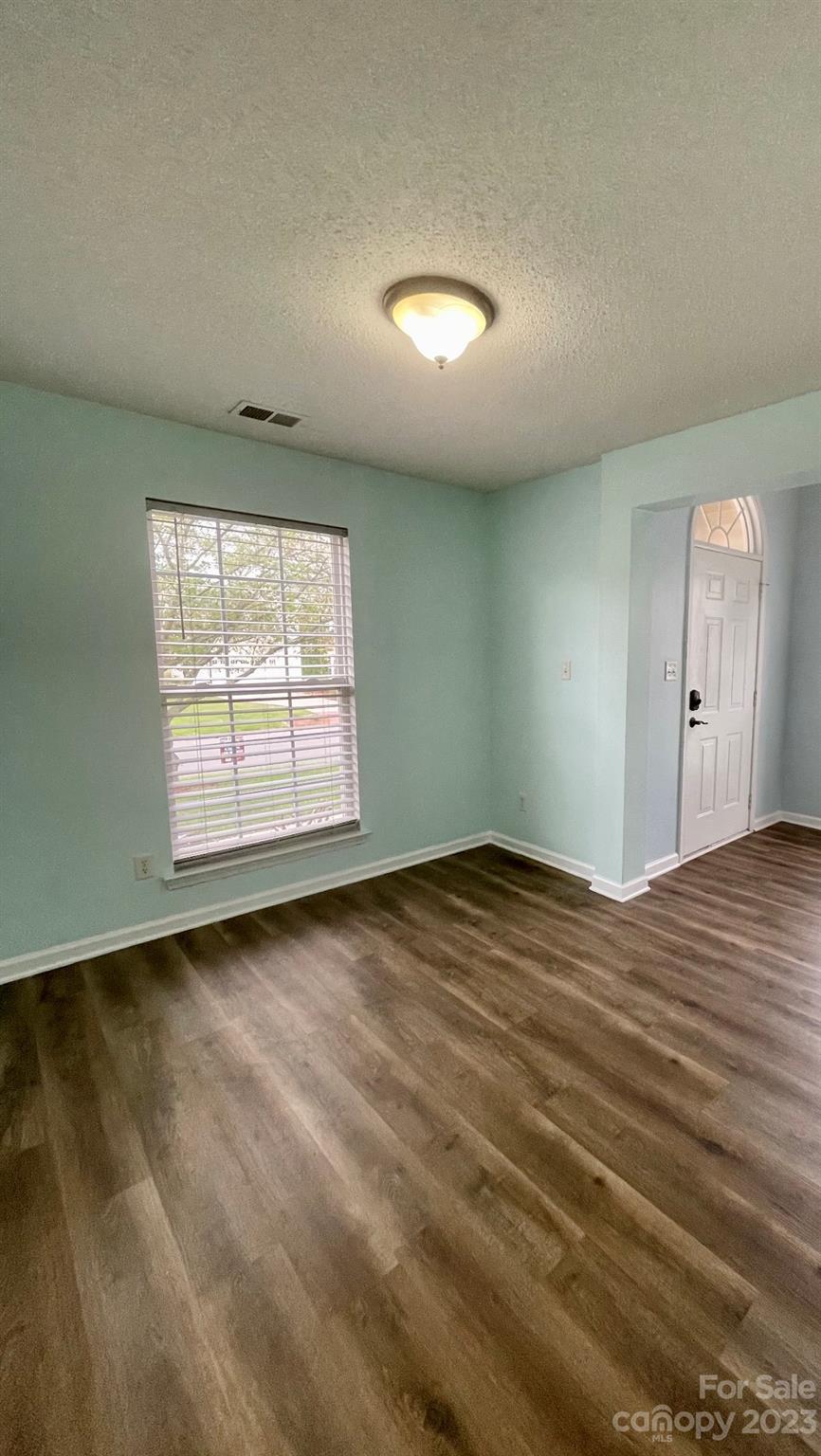 4045 Suttle Place Matthews, NC 28104 - Photo 10 of 42 an empty room with wooden floor and windows