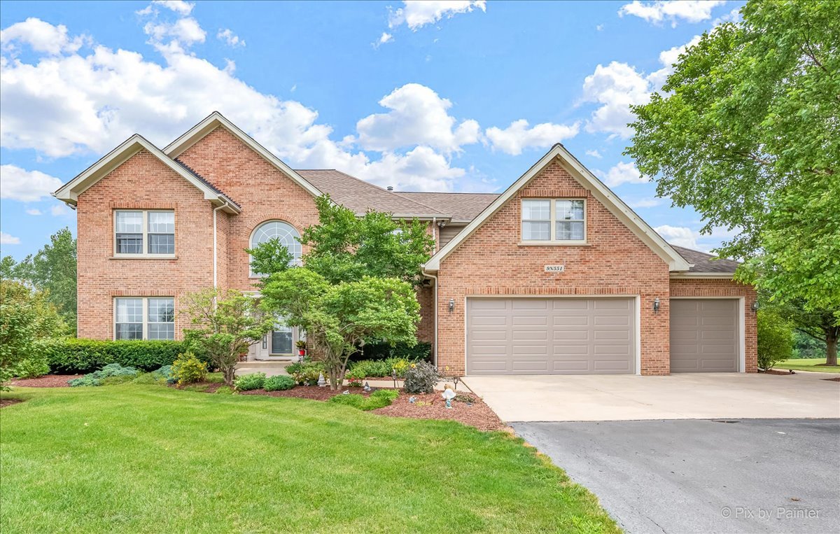 9N551 Dittman Road Elgin, IL 60124 - Photo 1 of 1 a front view of a house with a yard and garage