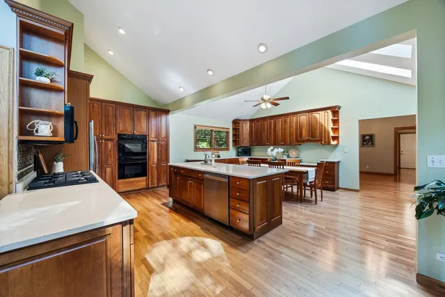 a kitchen with stainless steel appliances kitchen island granite countertop a stove and a refrigerator