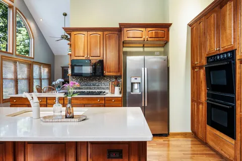 a kitchen with stainless steel appliances a sink stove and refrigerator