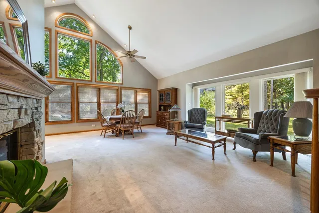 a living room with furniture and floor to ceiling windows