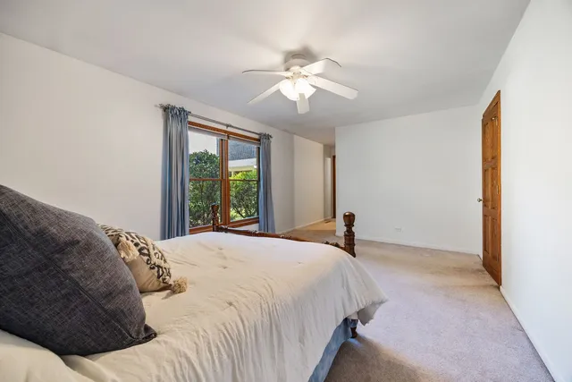 a bedroom with a large bed and a window