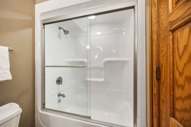 a bathroom with a glass shower door