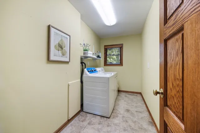 a view of a hallway and closet with wooden floor
