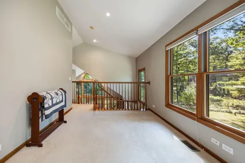 a view of hallway with furniture and windows
