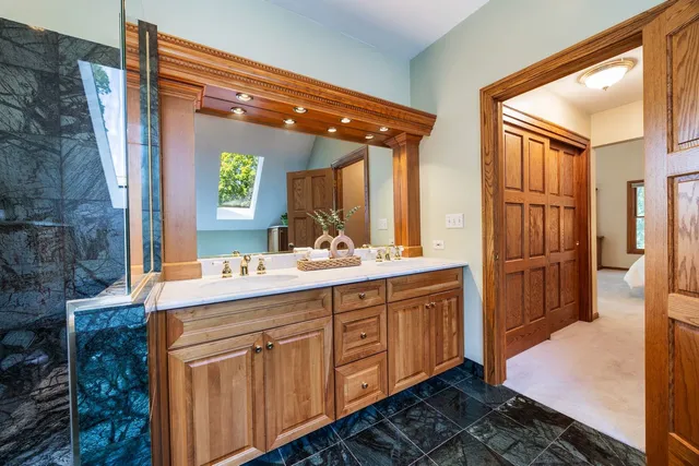 a bathroom with a sink a mirror and a shower