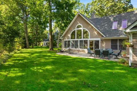 a view of a house with a yard and sitting area