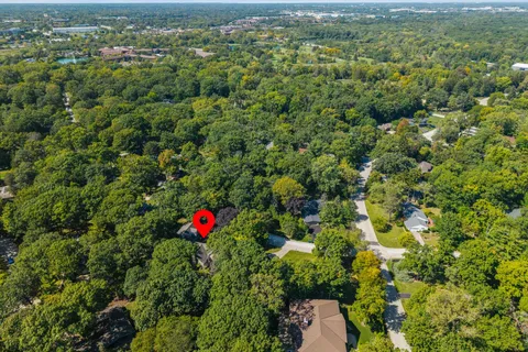 an aerial view of residential house with yard and outdoor space