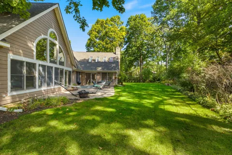 a swimming pool with outdoor seating and yard