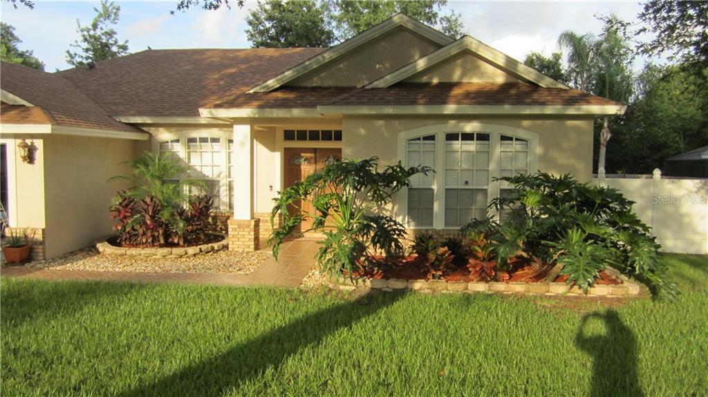 554 Safeharbour Drive Ocoee, FL 34761 - Photo 1 of 1 a front view of a house with a garden and yard