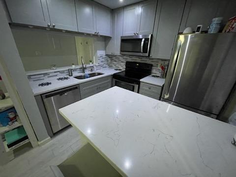 806 West 24th Street, Unit 116 Austin, TX 78705 - Photo 2 of 9 a kitchen with stainless steel appliances a sink a stove a microwave a refrigerator a sink and dishwasher