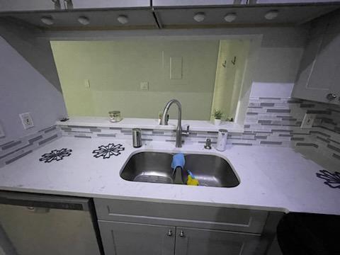 806 West 24th Street, Unit 116 Austin, TX 78705 - Photo 4 of 9 a kitchen with a sink and a stove with wooden floor