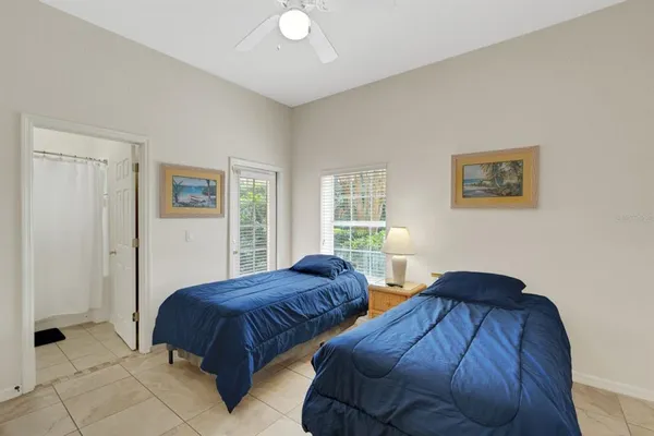 a bedroom with two beds and a window