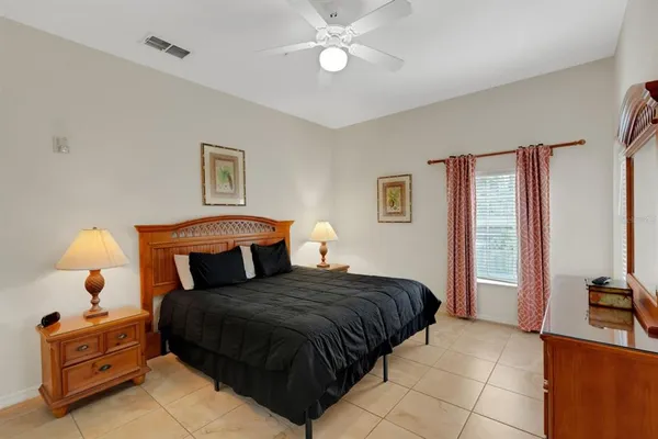 a bedroom with a large bed and a chandelier