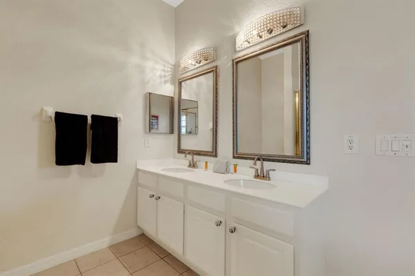 a bathroom with a double vanity sink and mirror