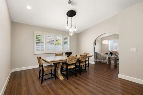 a view of a dining room with furniture window and wooden floor