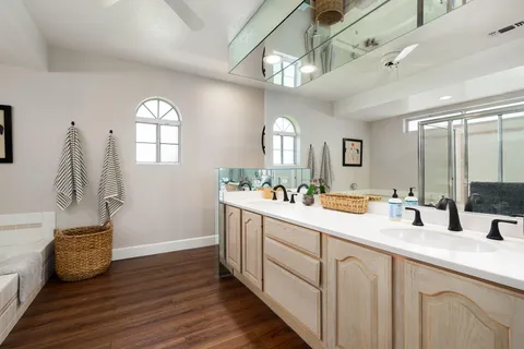 a bathroom with a tub shower and sink