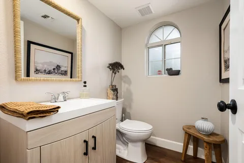 a bathroom with a double vanity sink toilet and shower