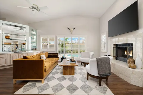a living room with furniture fireplace and a flat screen tv