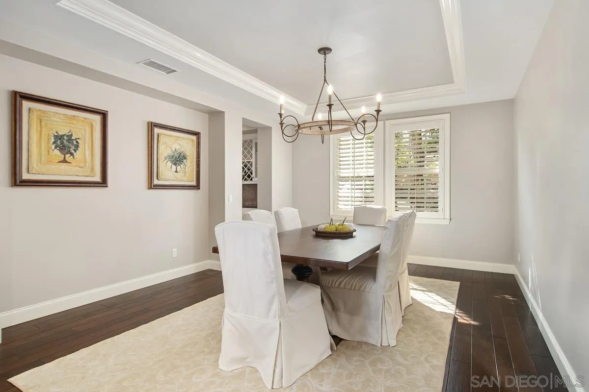 6941 Sitio Cordero Carlsbad, CA 92009 - Photo 11 of 44 a view of a dining room with furniture wooden floor and chandelier