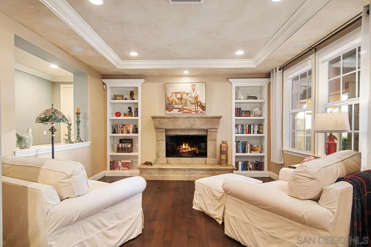 6941 Sitio Cordero Carlsbad, CA 92009 - Photo 13 of 44 a living room with furniture a fireplace and a large window
