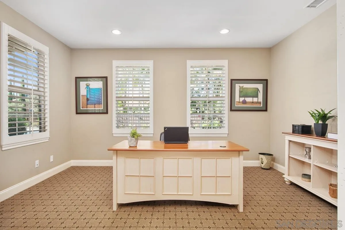 6941 Sitio Cordero Carlsbad, CA 92009 - Photo 14 of 44 a living room with stainless steel appliances kitchen island granite countertop a cabinets and a couch