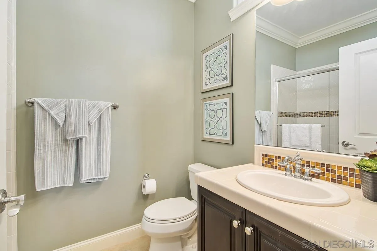 6941 Sitio Cordero Carlsbad, CA 92009 - Photo 23 of 44 a bathroom with a sink and a toilet