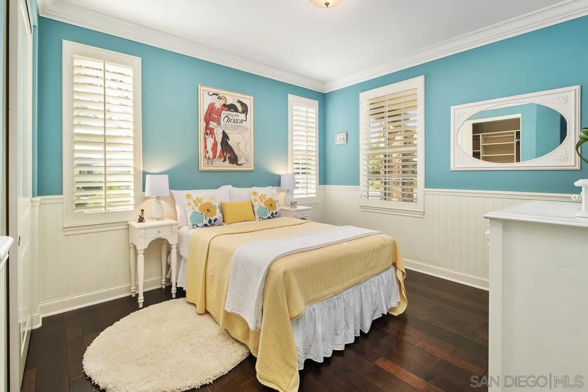 6941 Sitio Cordero Carlsbad, CA 92009 - Photo 24 of 44 a bedroom with a bed and wooden floor