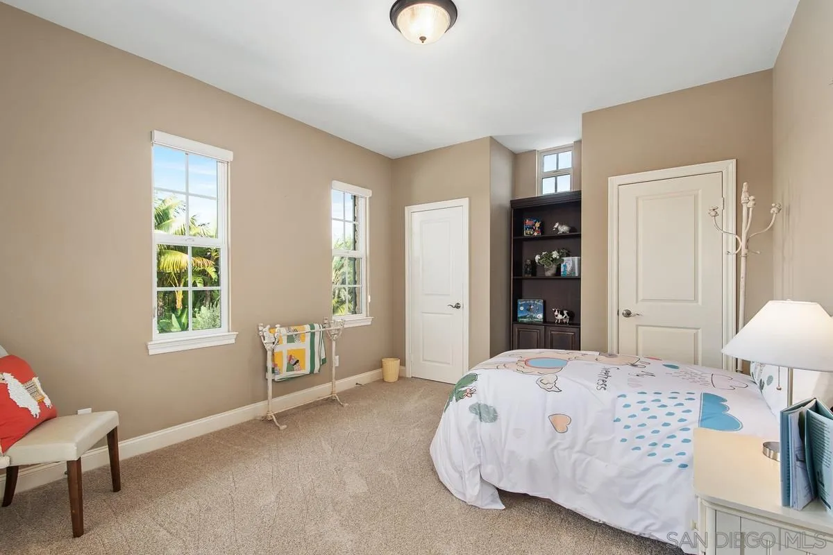 6941 Sitio Cordero Carlsbad, CA 92009 - Photo 26 of 44 a bedroom with a bed and a window