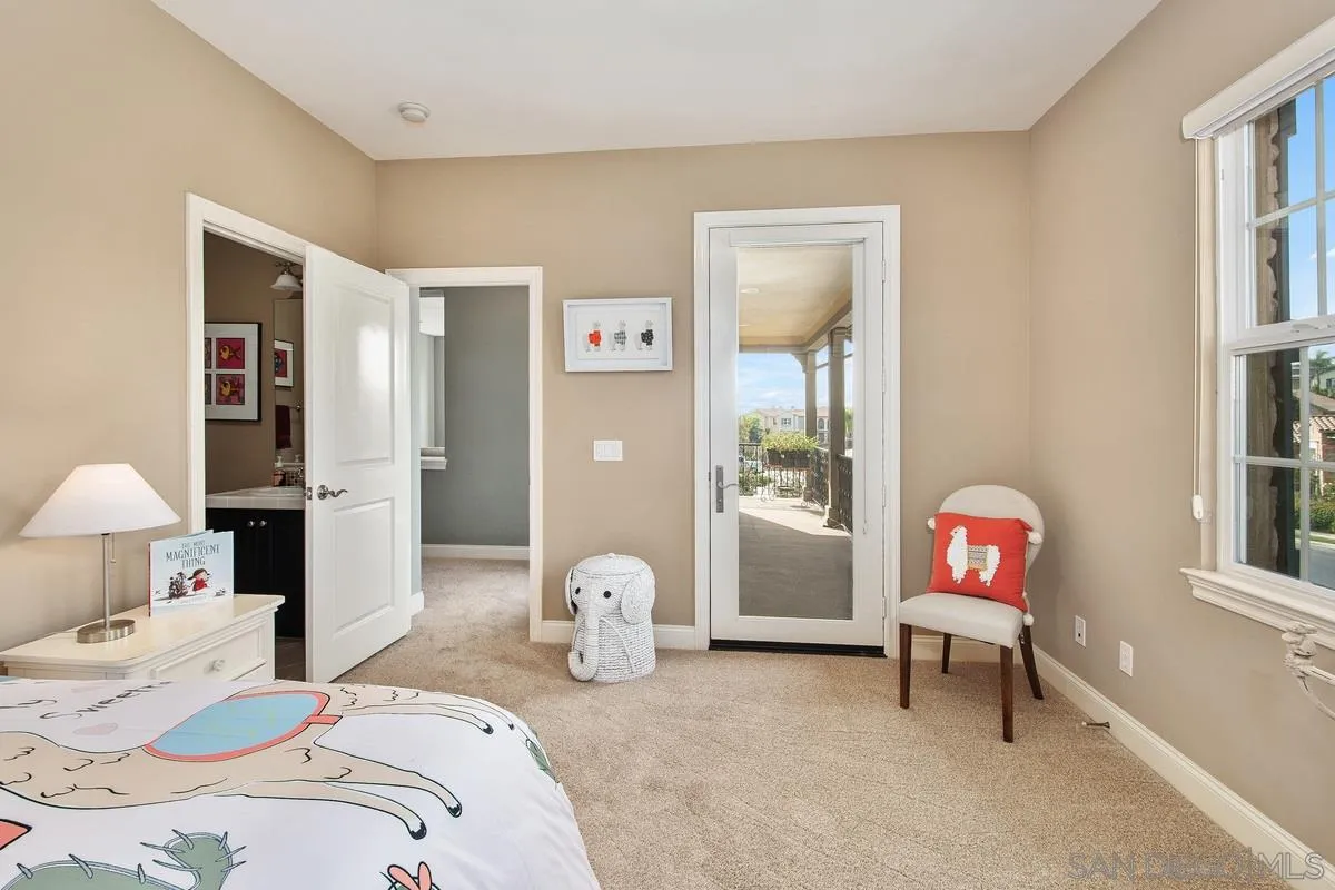 6941 Sitio Cordero Carlsbad, CA 92009 - Photo 27 of 44 a bedroom with bed and a window