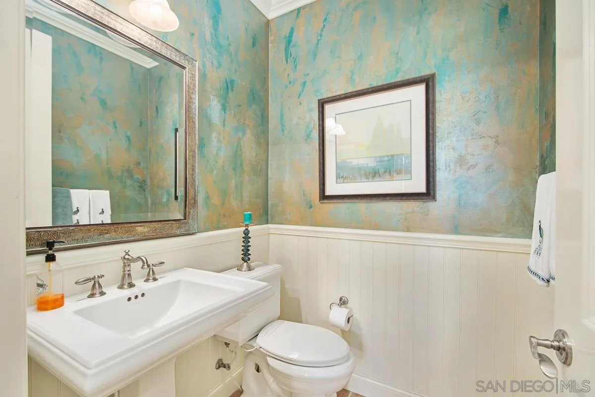 6941 Sitio Cordero Carlsbad, CA 92009 - Photo 30 of 44 a bathroom with a sink mirror and toilet