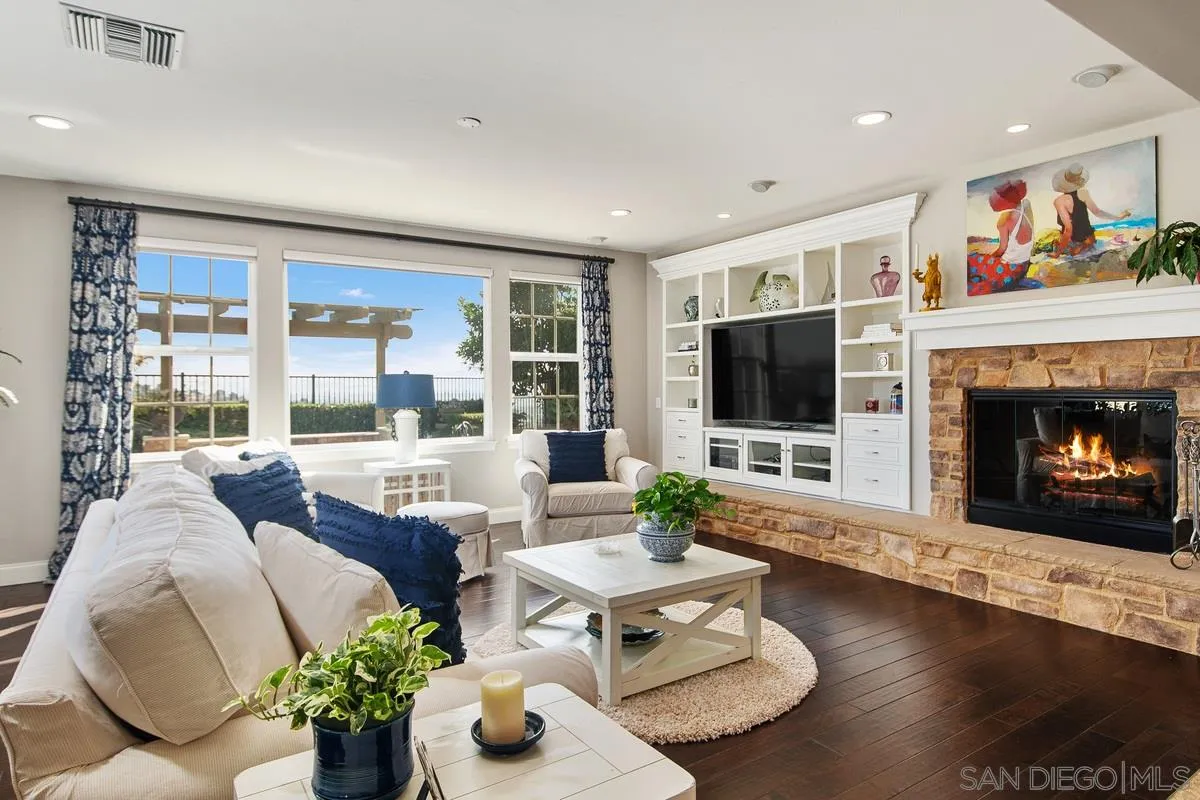 6941 Sitio Cordero Carlsbad, CA 92009 - Photo 3 of 44 a living room with furniture large window and a flat screen tv