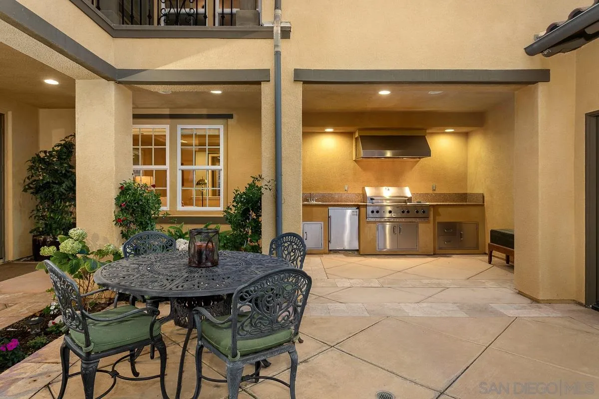 6941 Sitio Cordero Carlsbad, CA 92009 - Photo 38 of 44 a view of a patio with table and chairs and potted plants