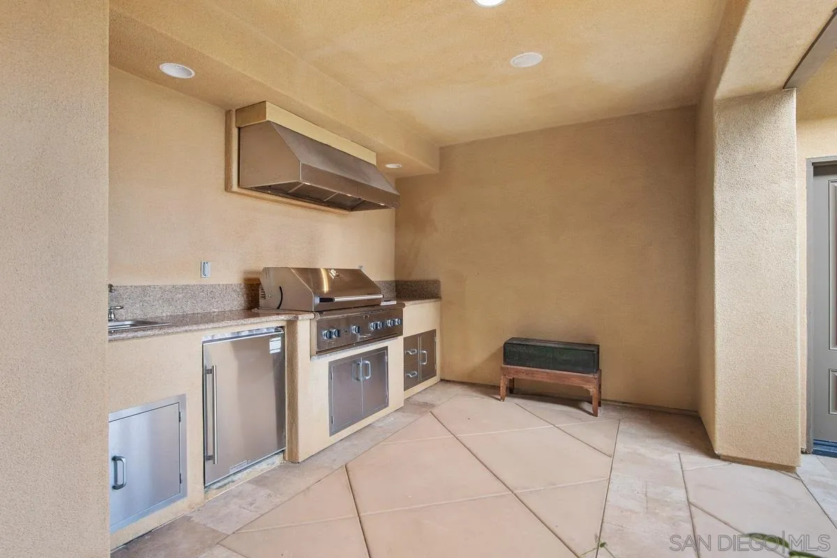 6941 Sitio Cordero Carlsbad, CA 92009 - Photo 41 of 44 a kitchen with stainless steel appliances granite countertop a stove and a refrigerator