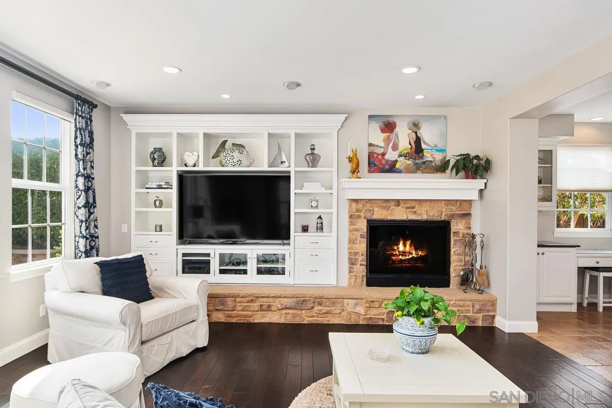6941 Sitio Cordero Carlsbad, CA 92009 - Photo 5 of 44 a living room with furniture a flat screen tv and a fireplace