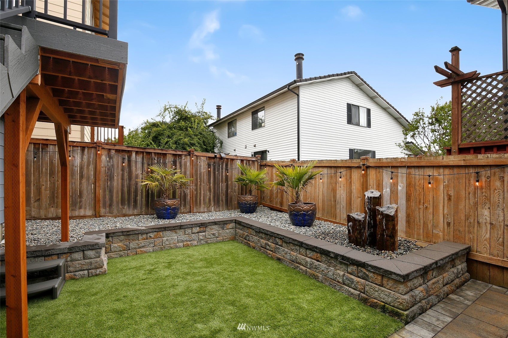 4127 Northeast 5th Court Renton, WA 98059 - Photo 12 of 36 a backyard of a house with table and chairs