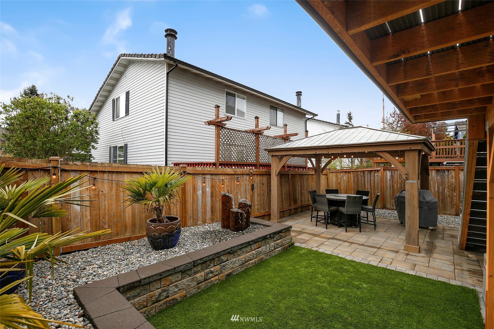 4127 Northeast 5th Court Renton, WA 98059 - Photo 13 of 36 a backyard of a house with yard table and chairs