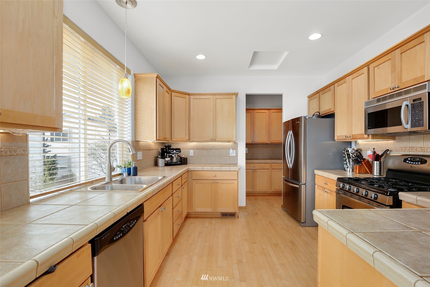 4127 Northeast 5th Court Renton, WA 98059 - Photo 17 of 36 a kitchen with a refrigerator a sink and a stove