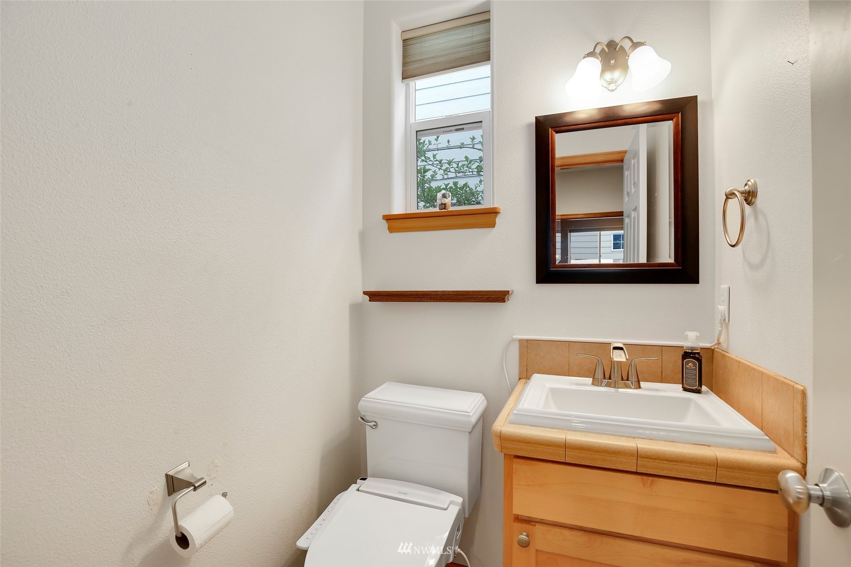 4127 Northeast 5th Court Renton, WA 98059 - Photo 23 of 36 a bathroom with a toilet sink and mirror
