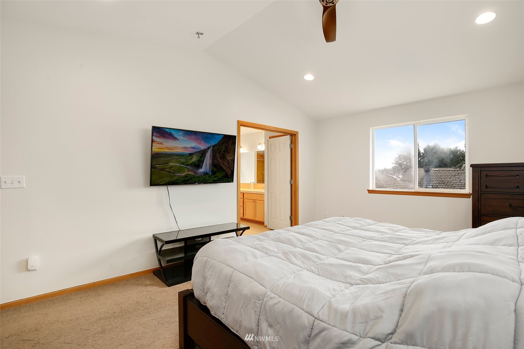 4127 Northeast 5th Court Renton, WA 98059 - Photo 25 of 36 a bedroom with a bed and a flat screen tv