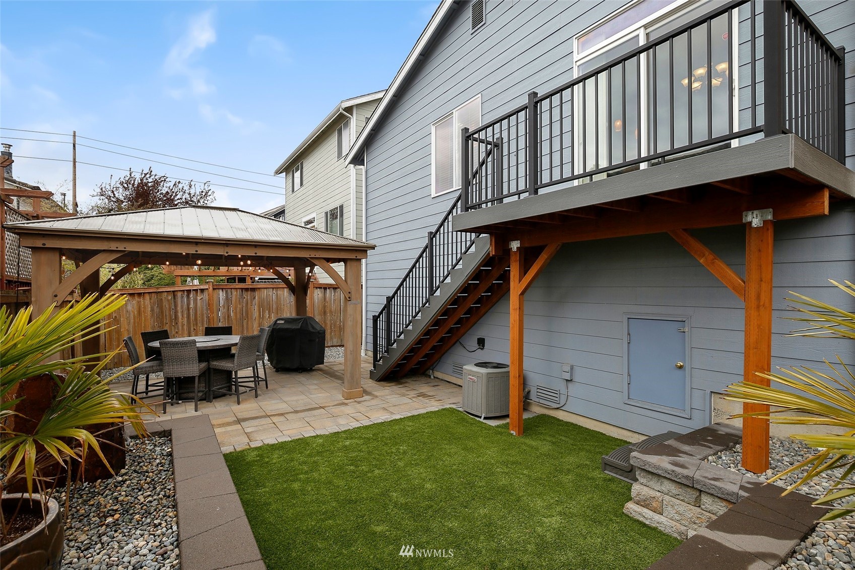 4127 Northeast 5th Court Renton, WA 98059 - Photo 10 of 36 a backyard of a house with table and chairs
