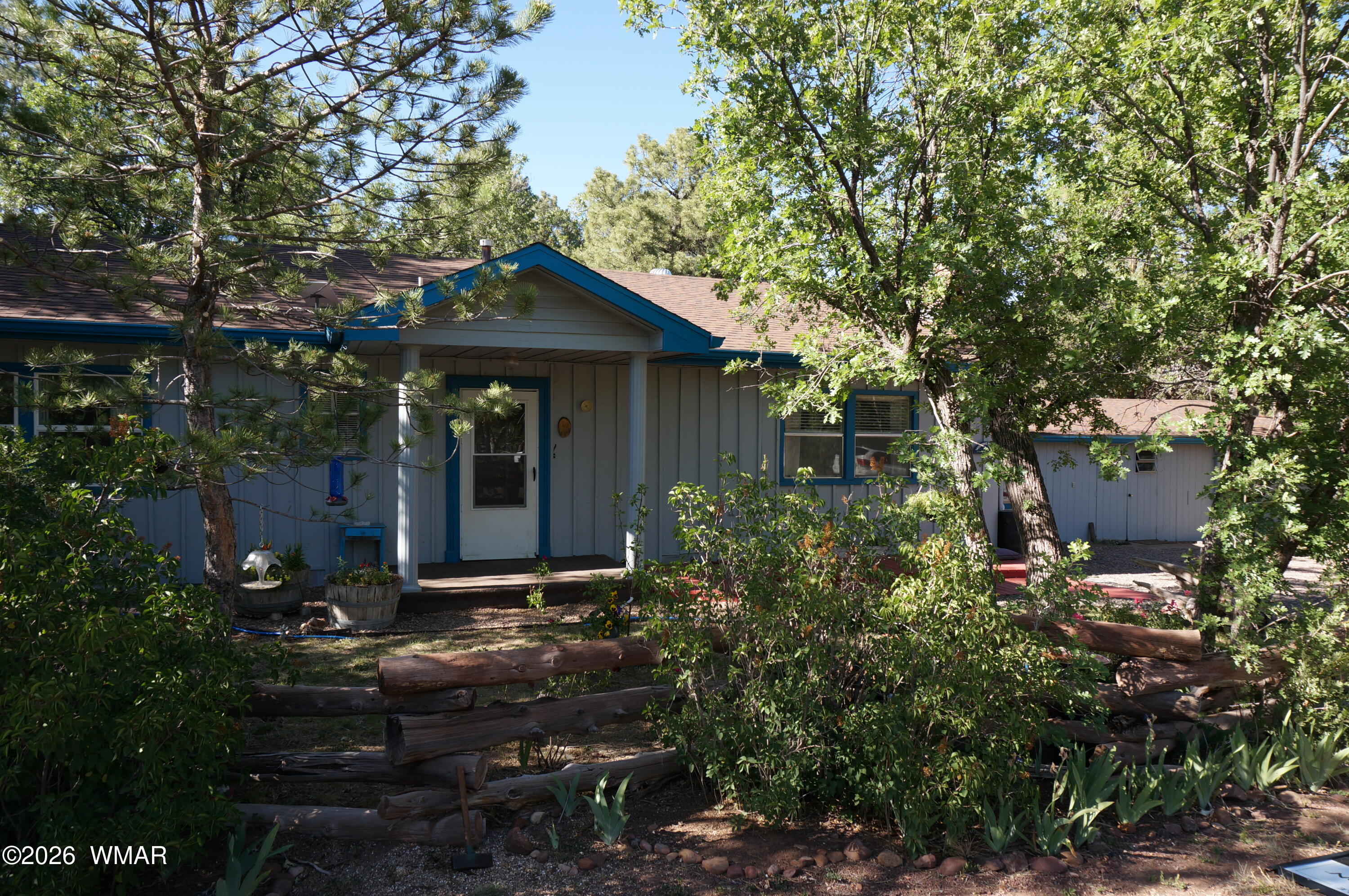 a view of house with backyard space and garden