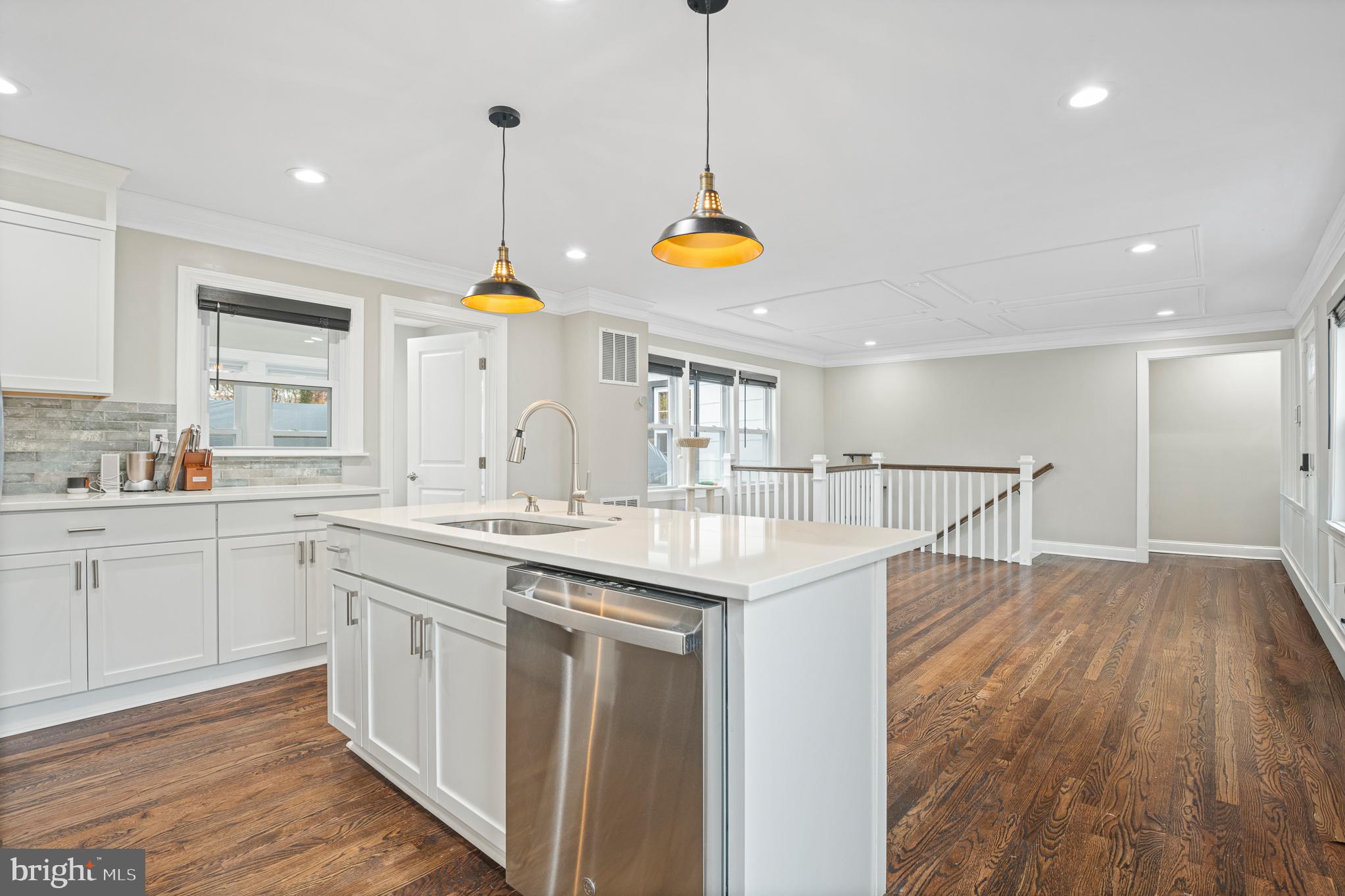 9217 Fowler Lane Lanham, MD 20706 - Photo 15 of 80 a kitchen with a sink a center island a stove and a window